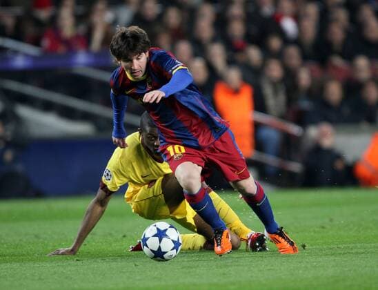 FC Barcelonas Lionel Messi tussles with Arsenals Abou Diaby UEFA Champions League 2nd Leg last 16 Barcelona v Arsenal 8th March, 2011 EDITORIAL USE ONLY. No use with unauthorised audio, video, data, fixture lists, club league logos or live services. Online in-match use limited to 120 images, no video emulation. No use in betting, games or single club league player publications.