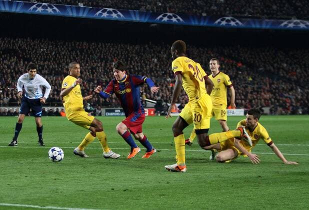 Barca s Lionel Messi runs through the Arsenal defence, FC Barcelona (blue red) - Arsenal FC London (yellow) - EDITORIAL USE ONLY. No use with unauthorised audio, video, data, fixture lists, club league logos or live services. Online in-match use limited to 120 images, no video emulation. No use in betting, games or single club league player publications.