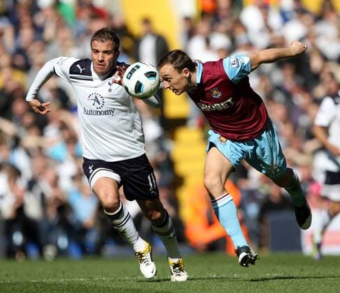 Tottenhams Rafael Van Der Vaart tussles with West Hams Mark Noble --- Tottenham Hotspur (white) vs. West Ham United (red) EDITORIAL USE ONLY. No use with unauthorised audio, video, data, fixture lists, club league logos or live services. Online in-match use limited to 120 images, no video emulation. No use in betting, games or single club league player publications.