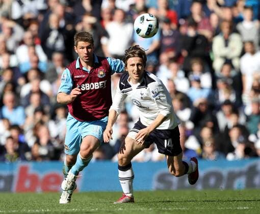 Tottenhams Luka Modric tussles with West Hams Thomas Hitzlsperger --- Tottenham Hotspur (white) vs. West Ham United (red) EDITORIAL USE ONLY. No use with unauthorised audio, video, data, fixture lists, club league logos or live services. Online in-match use limited to 120 images, no video emulation. No use in betting, games or single club league player publications.