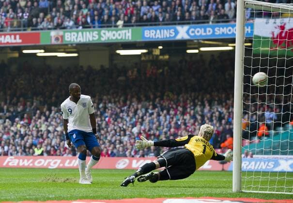 Darren Bent of England (L) scores the second goal past Wayne Hennessey of Wales European Championship Qualifying Group G Wales v England - EDITORIAL USE ONLY. No use with unauthorised audio, video, data, fixture lists, club league logos or live services. Online in-match use limited to 120 images, no video emulation. No use in betting, games or single club league player publications.