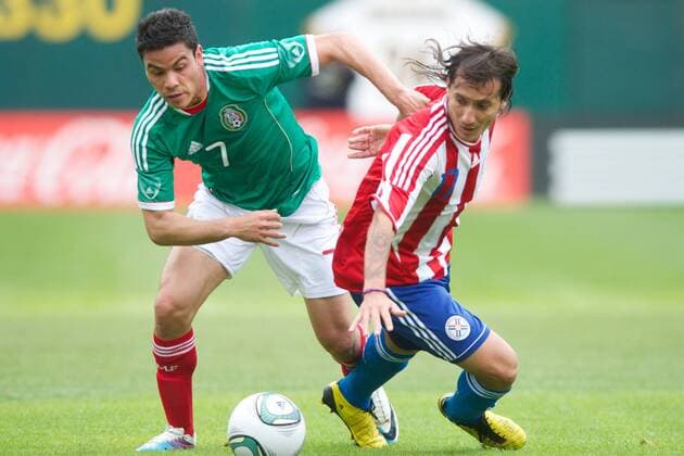 Mar. 26, 2011 - Oakland, California, U.S - Mexico forward Pablo Barrera (7) looks for a way around Paraguay midfielder Aureliano Torres (17) during the FIFA friendly match between Mexico and Paraguay at Oakland-Alameda County Coliseum in Oakland, CA. Mexico beat Paraguay 3-1. - ZUMAq48
