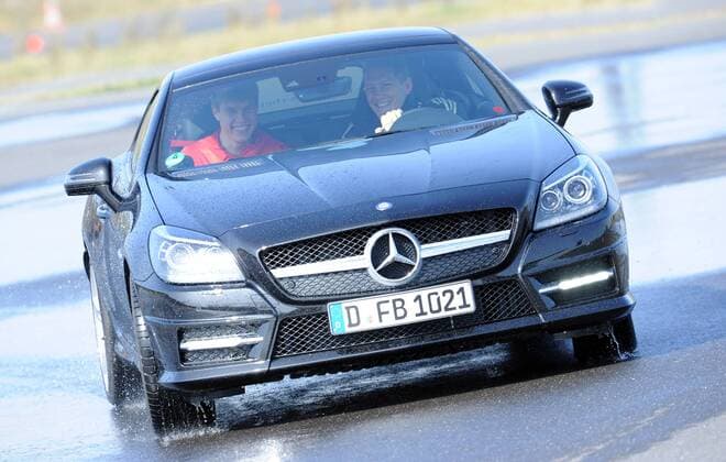Die Nationalspieler Bastian SCHWEINSTEIGER (r. am Steuer) und Holger BADSTUBER (l. DFB) fahren in einem Mercedes-Benz SLK 350 BlueEFFICIENCY. Fussball: Driving-Experience Fahrsicherheitstraining der deutschen Fussball Nationalmannschaft der Männer auf der Strecke des ADAC-Fahrsicherheitszentrum in Grevenbroich, 28.03.2011. Poolfoto.