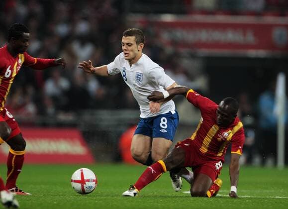 Jack Wilshere of England gets tackled by Emmanuel Agyemang-Badu of Ghana - Friendly England (white) v Ghana 29th March, 2011 EDITORIAL USE ONLY. No use with unauthorised audio, video, data, fixture lists, club league logos or live services. Online in-match use limited to 120 images, no video emulation. No use in betting, games or single club league player publications.