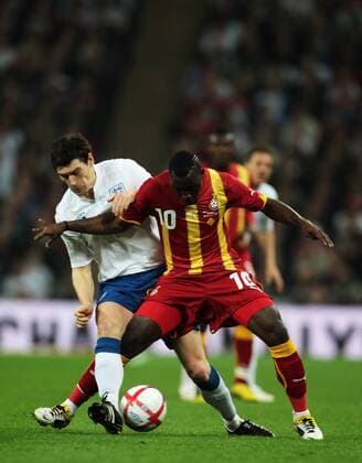 Gareth Barry of England tackles Kwadwo Asamoah of Ghana - Friendly England (white) v Ghana 29th March, 2011 EDITORIAL USE ONLY. No use with unauthorised audio, video, data, fixture lists, club league logos or live services. Online in-match use limited to 120 images, no video emulation. No use in betting, games or single club league player publications.