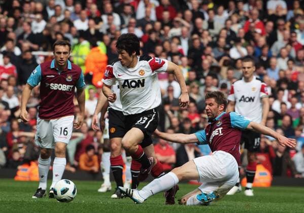 Ji-Sung Park (C) of Manchester United gets tackled by Thomas Hitzlsperger of West Ham - Barclays Premier League, London, West Ham United v Manchester United 2nd April, 2011 EDITORIAL USE ONLY. No use with unauthorised audio, video, data, fixture lists, club league logos or live services. Online in-match use limited to 120 images, no video emulation. No use in betting, games or single club league player publications. o0 Manu
