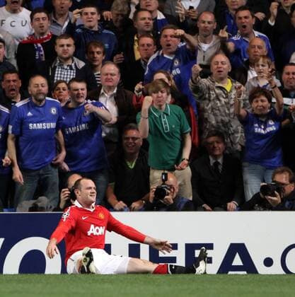 Chelsea FC London fans react as Manchester Uniteds Wayne Rooney celebrates scoring his sides opening goal UEFA Champions League quarter final 1st leg Chelsea FC London vs. Manchester United (Manu) 6th April, 2011 EDITORIAL USE ONLY. No use with unauthorised audio, video, data, fixture lists, club league logos or live services. Online in-match use limited to 120 images, no video emulation. No use in betting, games or single club league player publications.