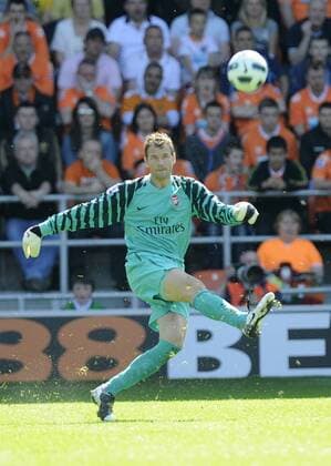 Jens Lehmann of FC Arsenal London (yellow) back in the first team clears the ball --- Barclays Premier League - Blackpool FC (orange) vs FC Arsenal London (yellow) 10th April, 2011 EDITORIAL USE ONLY. No use with unauthorised audio, video, data, fixture lists, club league logos or live services. Online in-match use limited to 120 images, no video emulation. No use in betting, games or single club league player publications.