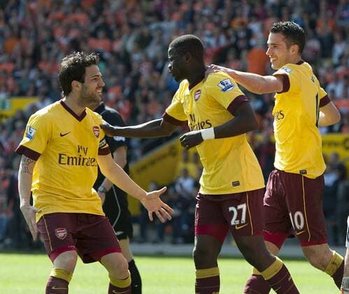 Emmanuel Eboue of FC Arsenal London (C) celebrates his goal with Cesc Fabregas of FC Arsenal London (L) and Robin Van Persie of FC Arsenal London (yellow) --- Barclays Premier League - Blackpool FC (orange) vs FC Arsenal London, 10th April, 2011 EDITORIAL USE ONLY. No use with unauthorised audio, video, data, fixture lists, club league logos or live services. Online in-match use limited to 120 images, no video emulation. No use in betting, games or single club league player publications. o0 Jubel Freude