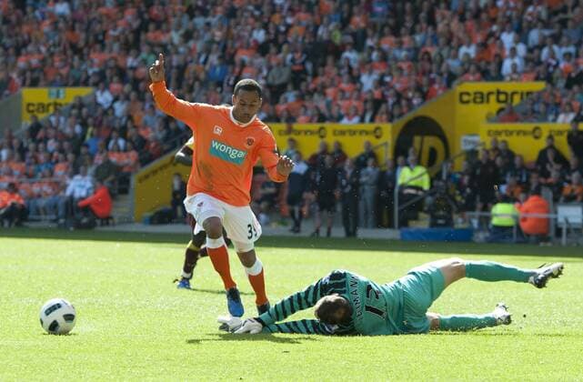 Jens Lehmann of FC Arsenal London (green) brings down D J Campbell of Blackpool FC (orange) which if Blackpool had not have scored from the advantage played might of been a red card for Lehmann --- Barclays Premier League - Blackpool FC (orange) vs FC Arsenal London, 10th April, 2011 EDITORIAL USE ONLY. No use with unauthorised audio, video, data, fixture lists, club league logos or live services. Online in-match use limited to 120 images, no video emulation. No use in betting, games or single club league player publications. o0 Foul Elfmeter