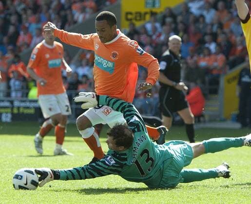 Jens Lehmann of FC Arsenal London (green) makes a fantastic save at the feet of D J Campbell of Blackpool FC (orange) --- Barclays Premier League - Blackpool FC (orange) vs FC Arsenal London, 10th April, 2011 EDITORIAL USE ONLY. No use with unauthorised audio, video, data, fixture lists, club league logos or live services. Online in-match use limited to 120 images, no video emulation. No use in betting, games or single club league player publications. o0 Abwehr