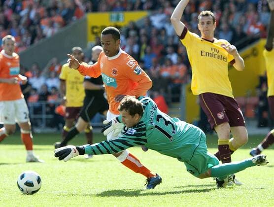 Jens Lehmann of FC Arsenal London (green) makes a fantastic save at the feet of D J Campbell of Blackpool FC (orange) --- Barclays Premier League - Blackpool FC (orange) vs FC Arsenal London, 10th April, 2011 EDITORIAL USE ONLY. No use with unauthorised audio, video, data, fixture lists, club league logos or live services. Online in-match use limited to 120 images, no video emulation. No use in betting, games or single club league player publications. o0 Abwehr