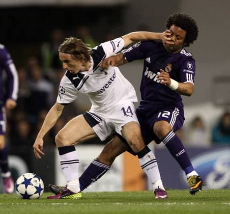 Tottenhams Luka Modric tussles with Madrids Marcelo UEFA Champions League quarter final 2nd leg Tottenham Hotspur (white) v Real Madrid (blue) 13th April, 2011 EDITORIAL USE ONLY. No use with unauthorised audio, video, data, fixture lists, club league logos or live services. Online in-match use limited to 120 images, no video emulation. No use in betting, games or single club league player publications.