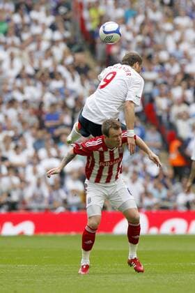London, FA Cup Semifinal, Bolton Wanderers (white) - Stoke City (red), Bolton Wanderers Johan Elmander climbs over Stoke City s Glenn Whelan for a header at Wembley 