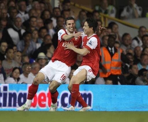 Arsenals Robin Van Persie celebrates scoring his sides third goal with Samir Nasri Barclays Premier League Tottenham Hotspur v Arsenal 20th April, 2011 EDITORIAL USE ONLY. No use with unauthorised audio, video, data, fixture lists, club league logos or live services. Online in-match use limited to 120 images, no video emulation. No use in betting, games or single club league player publications.