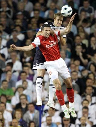 Tottenhams Michael Dawson tussles with Arsenals Robin Van Persie Barclays Premier League Tottenham Hotspur v Arsenal 20th April, 2011 EDITORIAL USE ONLY. No use with unauthorised audio, video, data, fixture lists, club league logos or live services. Online in-match use limited to 120 images, no video emulation. No use in betting, games or single club league player publications.