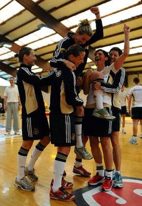 COLOGNE, GERMANY - APRIL 21: Simone Laudehr (top) celebrates with team mates during a Basketball training session at the German Women National Team training camp at Ballpark Köln on April 21, 2011 in Cologne, Germany. Simone Laudehr o0 DFB