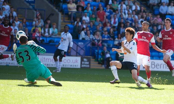 Chung Yong Lee of Bolton Wanderers (3R) sees his shot saved by Wojciech Szczesny (L) of Arsenal Barclays Premier League; Bolton Wanderers vs Arsenal FC London 24th April, 2011 EDITORIAL USE ONLY. No use with unauthorised audio, video, data, fixture lists, club league logos or live services. Online in-match use limited to 120 images, no video emulation. No use in betting, games or single club league player publications.