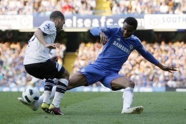 Football - Premiership - Chelsea FC London vs. Tottenham Hotspur; Chelsea s John Obi Mikel (R) tackles Tottenham Hotspur s Aaron Lennon at Stamford Bridge 