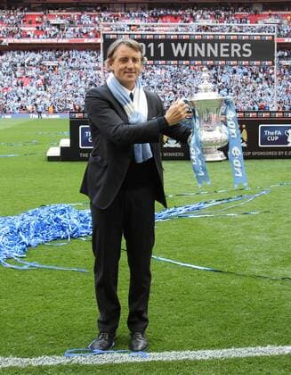 Manchester Citys coach Roberto Mancini with the trophy -- EON FA Cup Final Manchester City (blue) v Stoke City (red white) 14th May, 2011 EDITORIAL USE ONLY. No use with unauthorised audio, video, data, fixture lists, club league logos or live services. Online in-match use limited to 120 images, no video emulation. No use in betting, games or single club league player publications. o0 Pokal Objekte