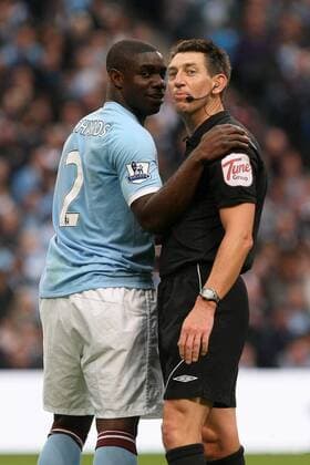 Football - Premier League - Manchester CIty vs. Stoke City Referee Lee Probert checks on Micah Richards of Manchester City after he blocks a shot with his head at the City of Manchester Stadium 
