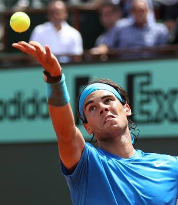 Rafael Nadal hits a serve during his French Open mens third round match at Roland Garros in Paris on May 28, 2011. Nadal defeated Veic 6-1, 6-3, 6-0 to advance to the fourth round.  PAR20110528730