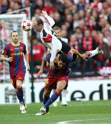 Manchester Uniteds Wayne Rooney tussles with Barcelonas Sergio Busquets UEFA Champions League Final Manchester United v Barcelona 28th May, 2011 EDITORIAL USE ONLY. No use with unauthorised audio, video, data, fixture lists, club league logos or live services. Online in-match use limited to 120 images, no video emulation. No use in betting, games or single club league player publications.