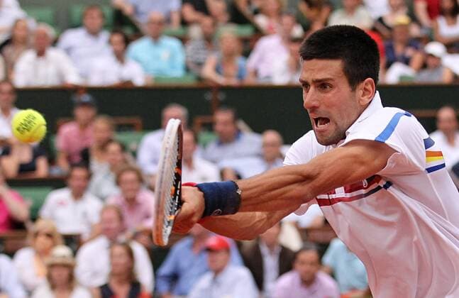 Serbian Novak Djokovic hits a shot during his French Open mens semifinal match at Roland Garros in Paris on June 3, 2011.  PAR20110603718