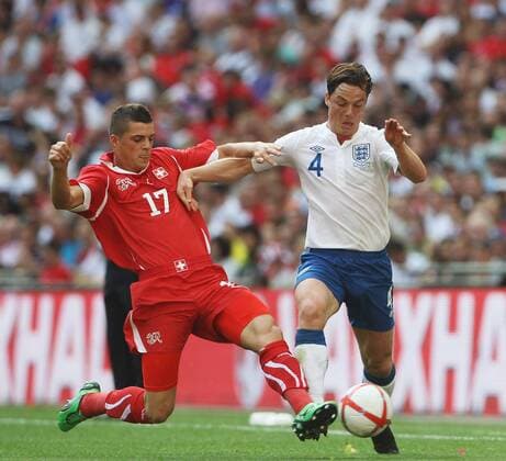 Scott Parker of England gets tackled by Granit Xhaka of Switzerland European Championship Qualifying Group G England v Switzerland 4th June, 2011 EDITORIAL USE ONLY. No use with unauthorised audio, video, data, fixture lists, club league logos or live services. Online in-match use limited to 120 images, no video emulation. No use in betting, games or single club league player publications.