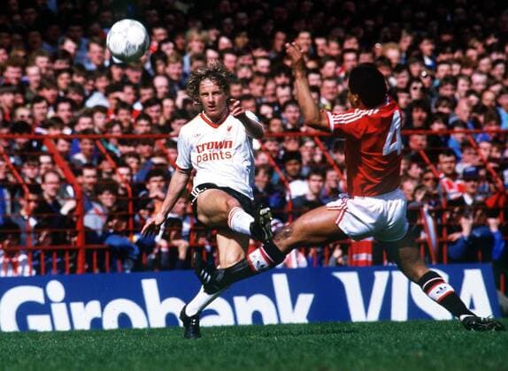 Paul Walsh (Liverpool FC) centers the ball from the advancing Remi Moses (Man utd). Manchester United v Liverpool FC. 1985 86.  ManU