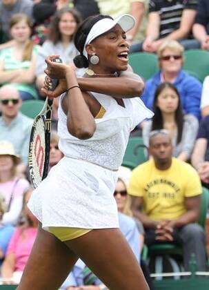 American Venus Williams returns the ball in her match on the opening day of the 125th Wimbledon Championships in Wimbledon,London on Monday June 20 2011.  LON2011062017