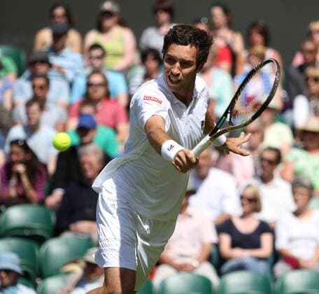 Kazakhstan s Mikhail Kukushkin returns the ball in his match on the second day of the 125th Wimbledon Championships in Wimbledon,England on Tuesday, June 21, 2011.  LON2011062113