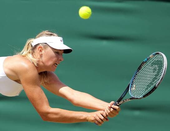 LONDON, June 27, 2011 -- Maria Sharapova of Russia returns the ball during the women s singles fourth round match at the 2011 Wimbledon tennis championships in London, England, June 27, 2011. 