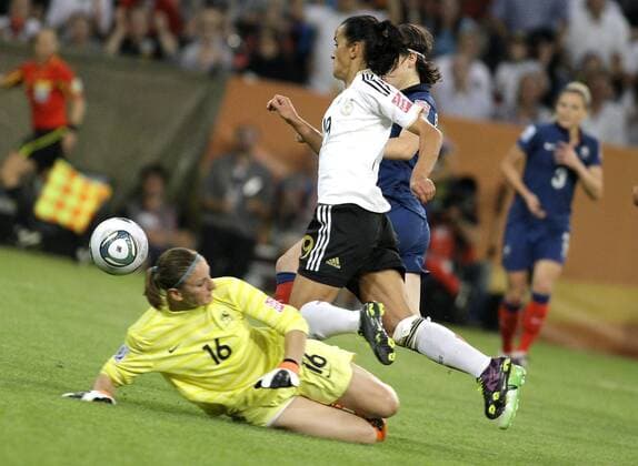 Germany s Fatmire BAJRAMAJ (GER) (M) falls against France s Berangere SAPOWICZ (FRA) and gets a penalty during the match of the Women s Soccer World Cup between Germany and France, BorussiaPark in Mönchengladbach on July 05., 2011. Mika
