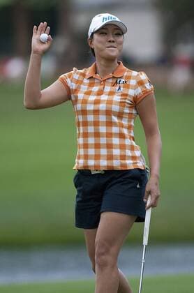 The clubhouse leader Korean Hee Kyoung Seo waves to fans still left in the stands on the 18th hole after finishing at three under par during the final round of the U.S. Women s Open at the Broadmoor East Course in Colorado Springs on July 10, 2011. Play was suspended three hours due to weather before the horn went off again signaling end of play due to darkness.  COS2011071045
