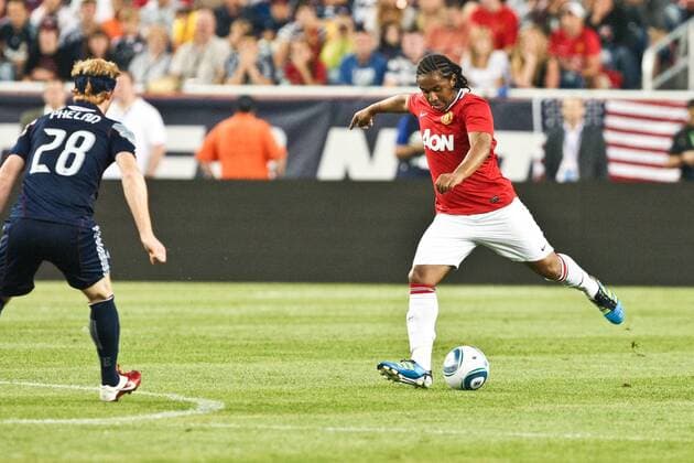 July 13, 2011 - Foxborough, Massachuestts, U.S - Manchester United midfielder Anderson (8) kicks the ball past New England Revolution midfielder Pat Phelan (28) at midfield during the first half of the match. Manchester United defeated the New England Revolution 4 - 1. MLS Fussball Herren USA 2011- July 13 - New England Revolution vs Manchester United - ZUMAx25