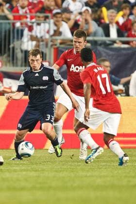 July 13, 2011 - Foxborough, Massachuestts, U.S - New England Revolution midfielder Zak Boggs (33) moves the ball past Manchester United midfielder Nani (17) during the first half of the match. Manchester United defeated the New England Revolution 4 - 1. MLS Fussball Herren USA 2011- July 13 - New England Revolution vs Manchester United - ZUMAx25