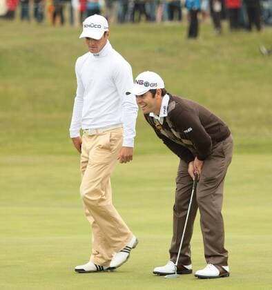 South African Louis Oosthuizen smiles beside Martin Kaymer after a birdie on the 9th green on the first day of the 140th Open Championship at Royal St Georges Golf club in Sandwich, England on Thursday, July 14, 2011.  LON2011071427