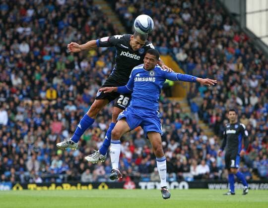 Football - Pre-Season Friendly - FC Portsmouth vs. FC Chelsea London --- Portsmouth s Tal Ben Haim heads clear from Chelsea s Billy Clifford at Fratton Park 