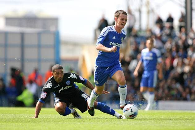 Football - Pre-Season Friendly - FC Portsmouth vs. FC Chelsea London --- Chelsea s Josh McEachran skips over the tackle from Portsmouth s Hayden Mullins at Fratton Park during there pre-season friendly  o0 Mc Eachran