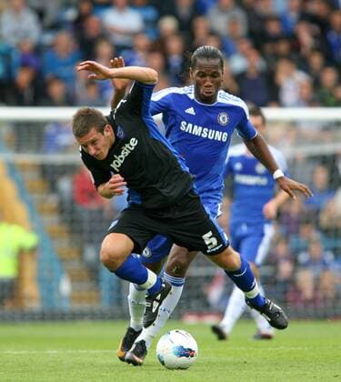 Football - Pre-Season Friendly - FC Portsmouth vs. FC Chelsea London --- Portsmouth s Jason Pearce holds off Chelsea s Didier Drogba at Fratton Park during there pre-season friendly 