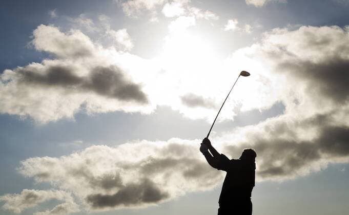 Golf - The Open 2011 - Royal St George s - Day 3 Darren Clarke (NI) tees off on the 18th green to finish his third round in the lead at 5 under, at Royal St George s, Sandwich  o0 Perspektive Gegenlicht Silhouette Symbol Golfer Wolken