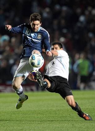 SANTA FE, July 16, 2011 -- Argentina s soccer player Lionel Messi (L-Top) vies for the ball with Andres Scotti (R-Buttom) of Uruguay, during the match of quarterfinals of Copa America 2011, Argentina vs Uruguay, in Santa Fe city, Argentina, on July 16, 2011. --- 