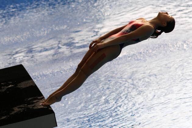 Jul 23, 2011 - Shanghai - HE ZI of China leans back for a practice dive before the women s 3 meter springboard diving final at the FINA World Championships. She won silver, following behind teammate Wu Minxia. Earlier, the pair won gold in the synchronized event. Swimming 2011 - FINA World Championships - Day 9 - ZUMAbr5