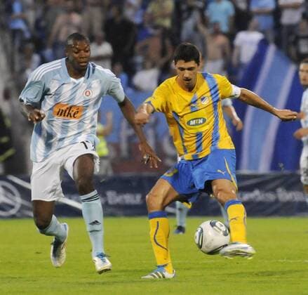 Karim Guede of Slovan Bratislava, left, fights for the ball with Apoel Nicosia player Helio Pinto, right, during their Champions League 3rd qualifying round, second leg match in Bratislava, Slovakia, Wednesday, Aug. 3, 2011. (CTKxPhoto JanxKoller)  CTKPhoto0201108030934901