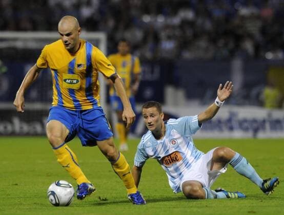 Erik Grendel, right, of Slovan Bratislava looses the ball in a duel with Apoel Nicosia player Paolo Gomes, left, during their Champions League 3rd qualifying round, second leg match in Bratislava, Slovakia, Wednesday, Aug. 3, 2011. (CTKxPhoto JanxKoller)  CTKPhoto0201108030972101