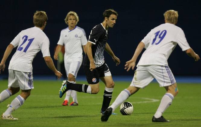 Zagreb, 03.08.2011., 3rd qualifying round, UEFA Champions League quali, NK Dinamo Zagreb (black) - HJK Helsinki (white) 1:0 - Milan Badelj (Dinamo-16) and Mikko Sumusalo (Helsinki-21) (L) Aki Riihilahti (Helsinki-19) (R)