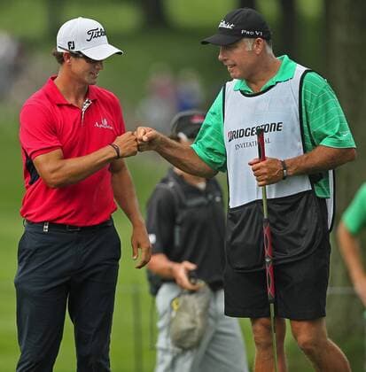 Aug. 4, 2011 - Akron, OH, USA - Adam Scott, left, celebrates with caddy Steve Williams after sinking a birdie putt on the 17th hole during the opening round at the 2011 WGC-Bridgestone Invitational at Firestone Country Club on Thursday, August 4, 2011, in Akron, Ohio. Scott carried a one-stroke lead into the clubhouse after an 8-under round of 62. GLF-BRIDGESTONE - ZUMAm67