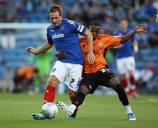 Football Carling Cup Round One - FC Portsmouth vs. Barnet FC, at Fratton Park: Portsmouth s Liam Lawrence battles with Barnet s Mark Marshall 09 08 2011 