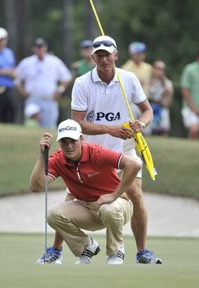 Martin Kaymer (L) of Germany and his caddie Christian Donald walks up to the 15th green during the first round of the 93rd PGA Golf Herren Championship at the Atlanta Athletic Club on August 11, 2011 in Johns Creek, Georgia.  BKX2011081173